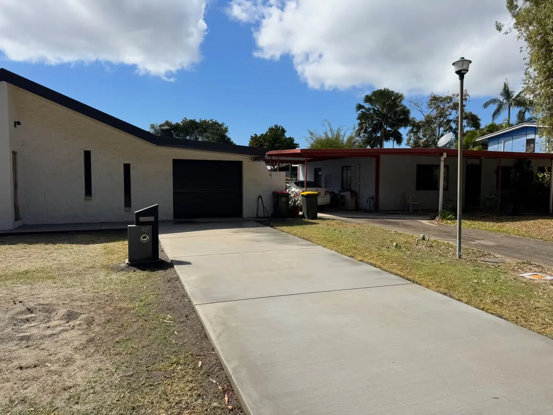 New concrete driveway leading to a garage