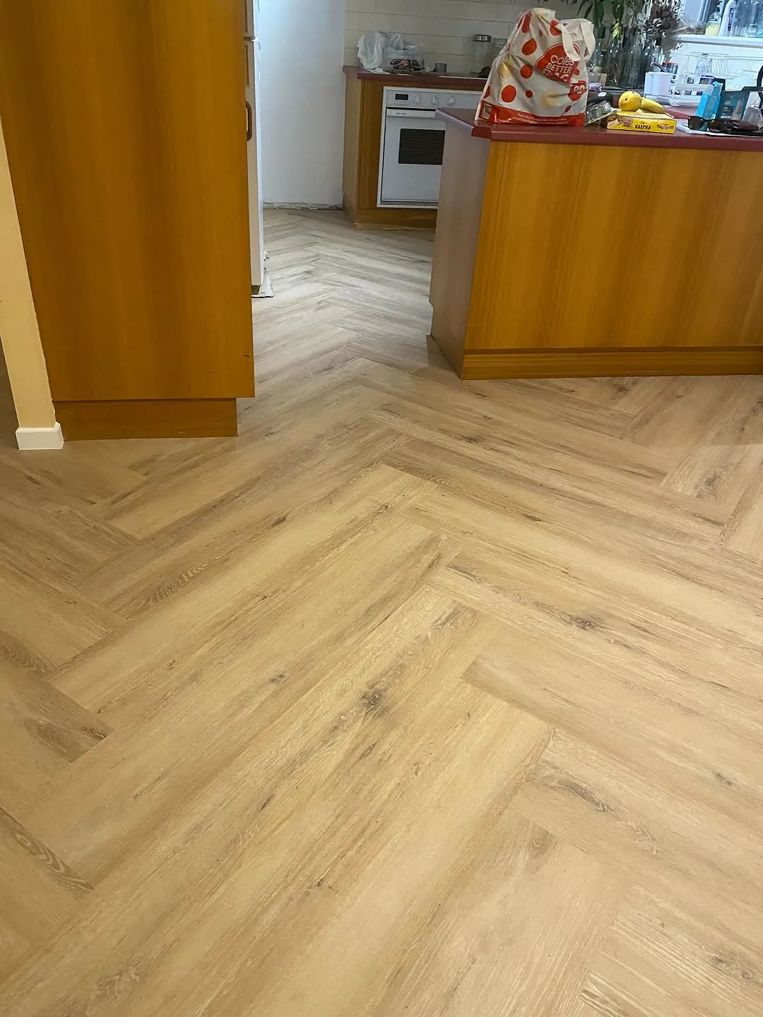 Herringbone overlay floor laid through a kitchen