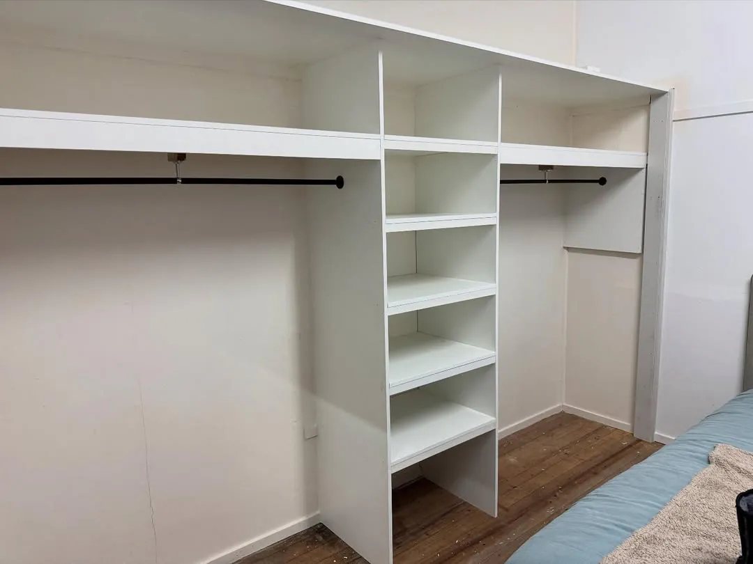 Built-in wardrobe with hanging rails and shelves
